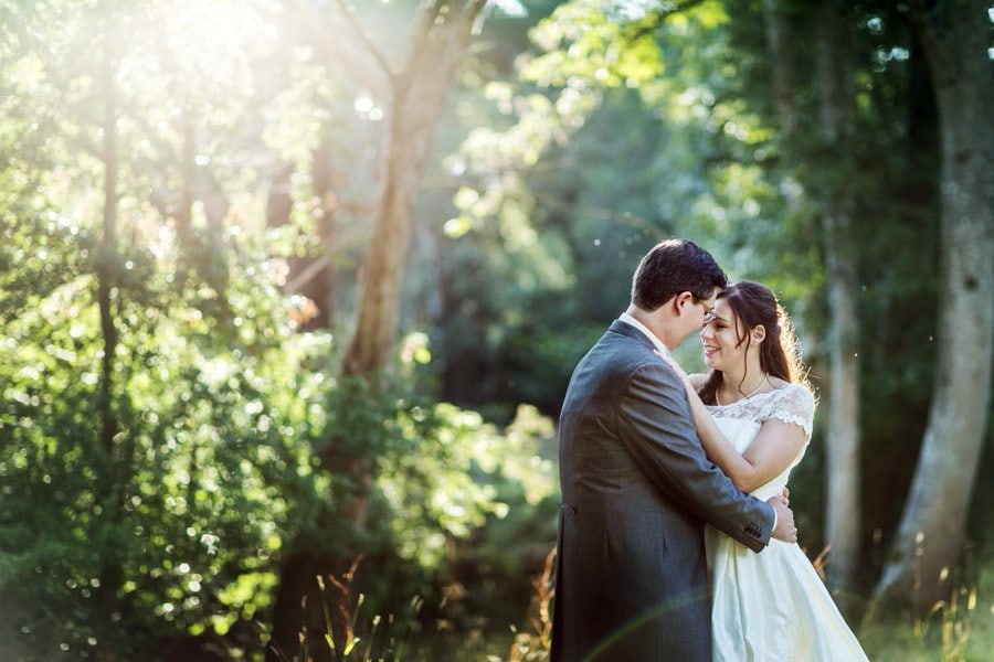bride and groom embracing in sunlight at Peterstone Court wedding
