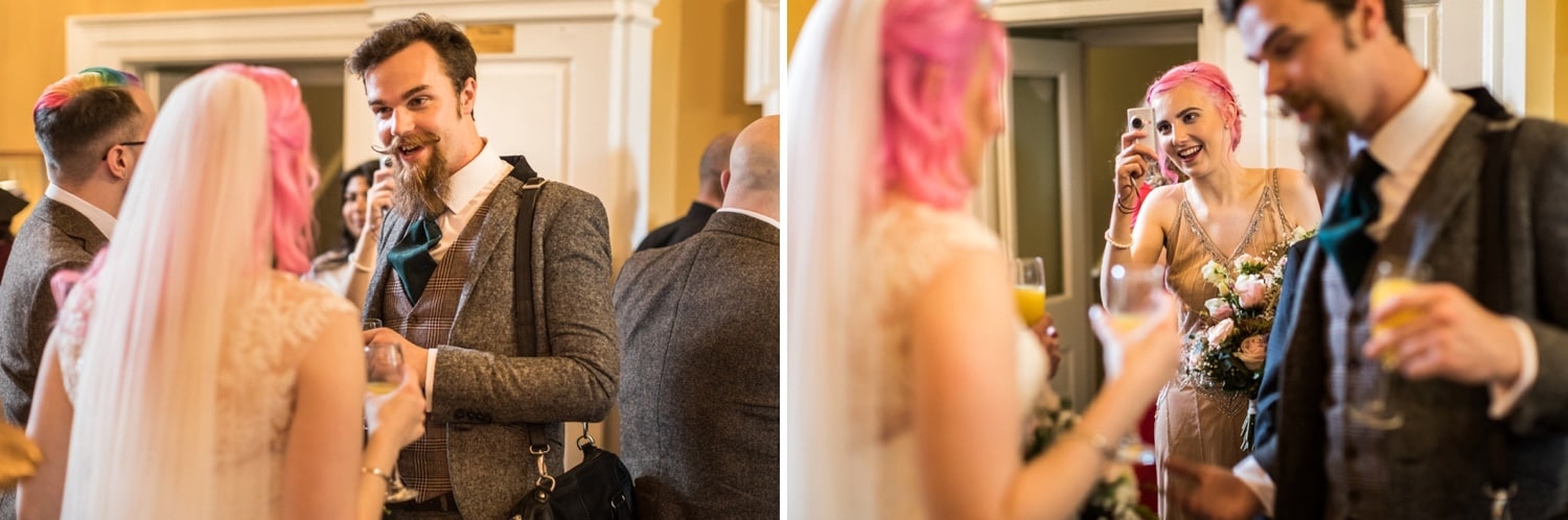 Bride with pink hair and groom with multi coloured hair getting married at Peterstone Court