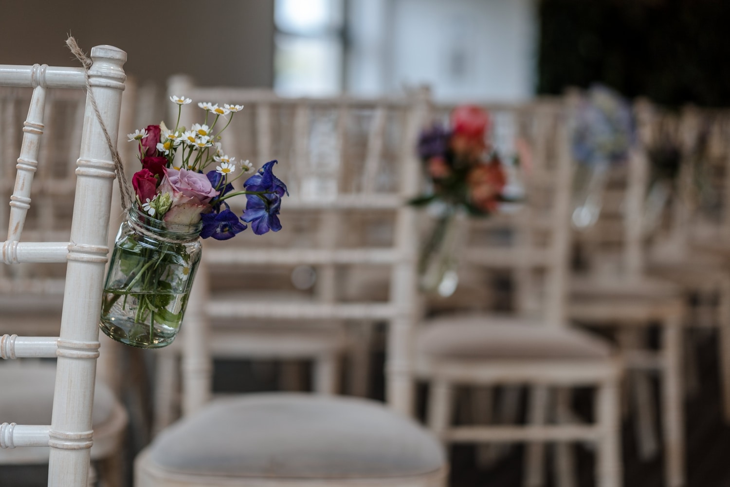 Flowers on chairs for wedding ceremony