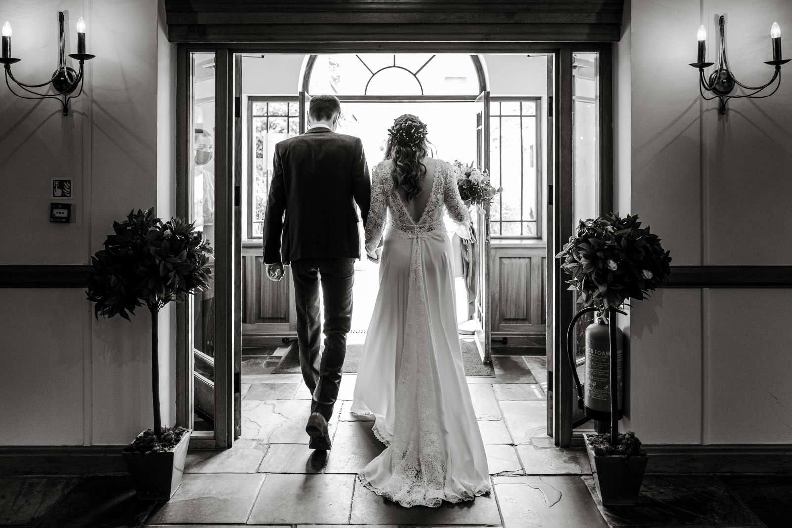 Bride and groom leaving marriage ceremony room at King Arthur Hotel, South Wales