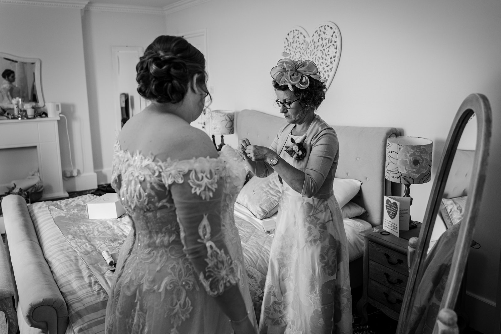 Mum helps daughter with wedding dress