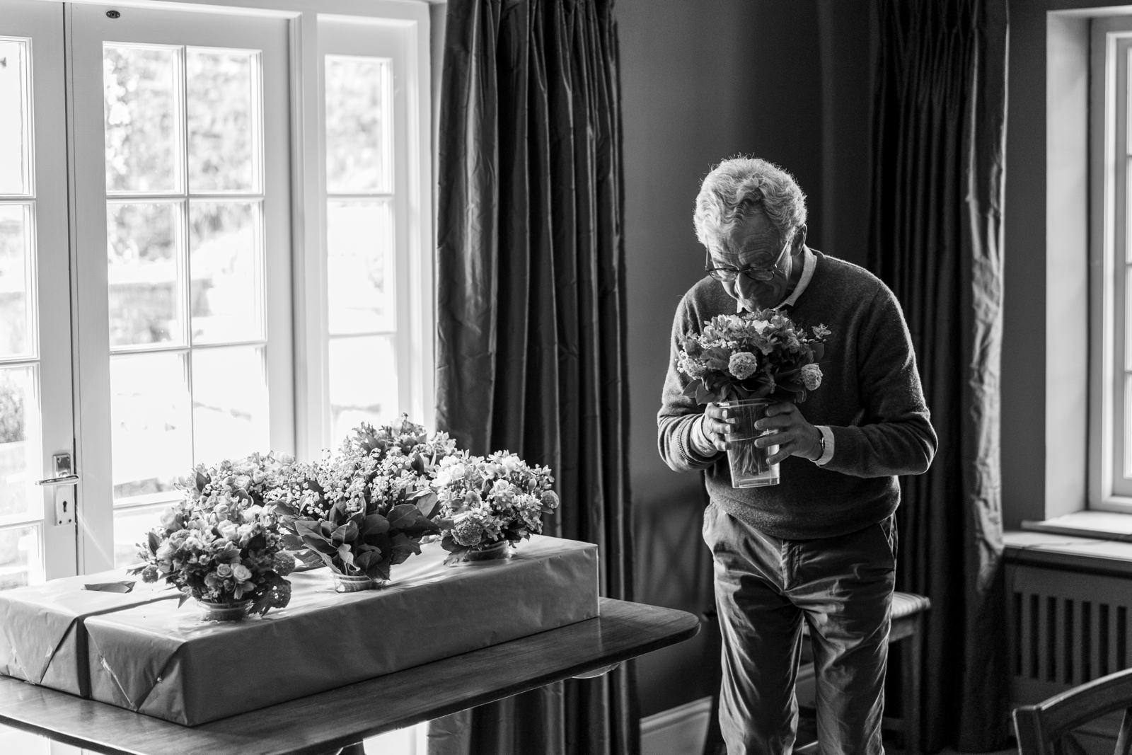 father of the bride smelling flowers 