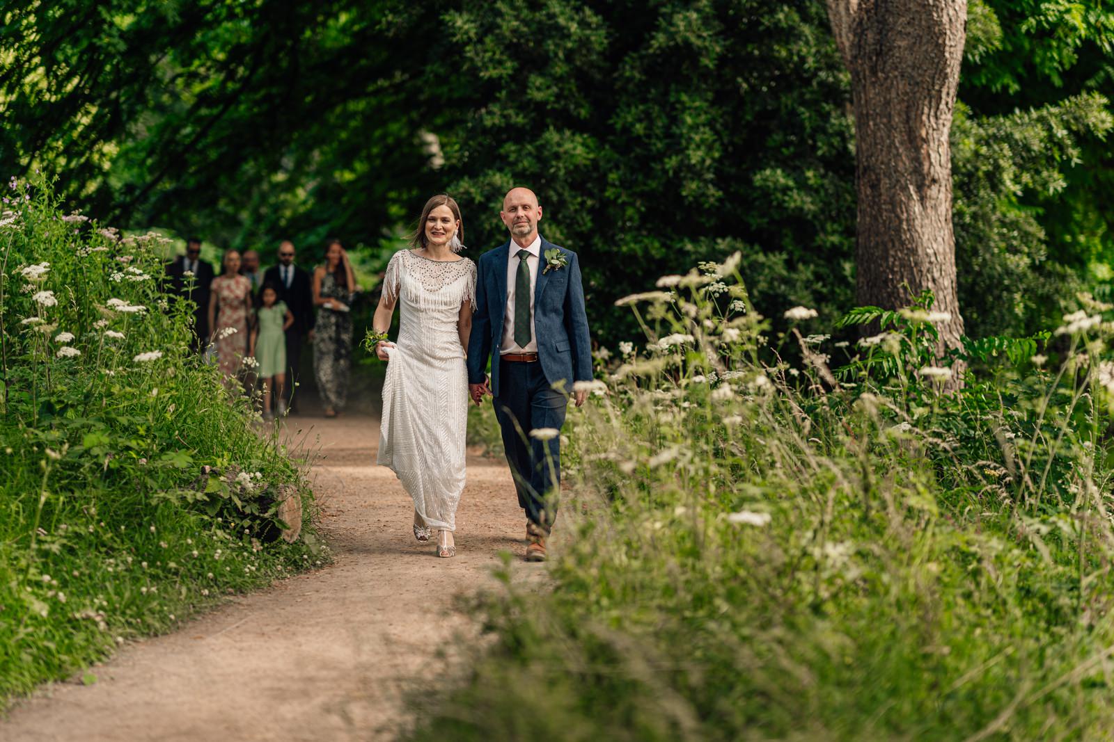 Bride and groom leading guests to Royal Welsh College of Music & Drama