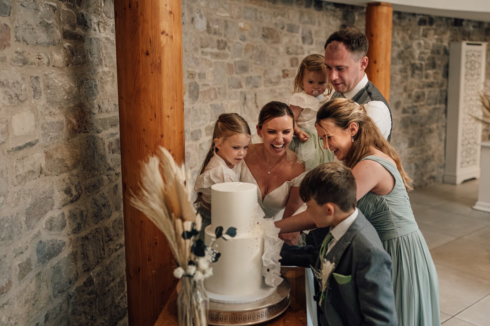 couple and children cutting cake