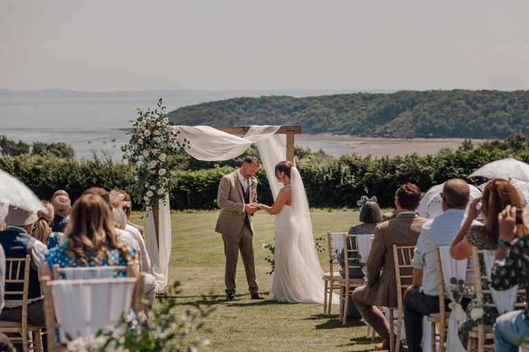 Couple exchanging vows at outdoor wedding, Perriswood, Gower, Wales